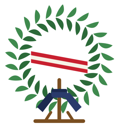A green memorial wreath on a stand with a red, white and blue ribbon across it.