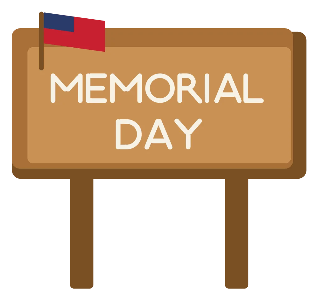 A wooden sign board on two posts reading Memorial Day, with a small flag at the corner.