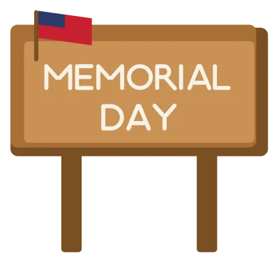 A wooden sign board on two posts reading Memorial Day, with a small flag at the corner.