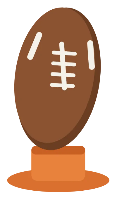 A brown american football standing upright on a small orange kicking tee.