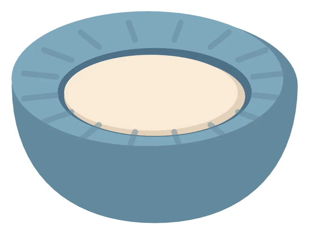 A round blue cat bed with a raised padded rim and a cream cushion in the middle.